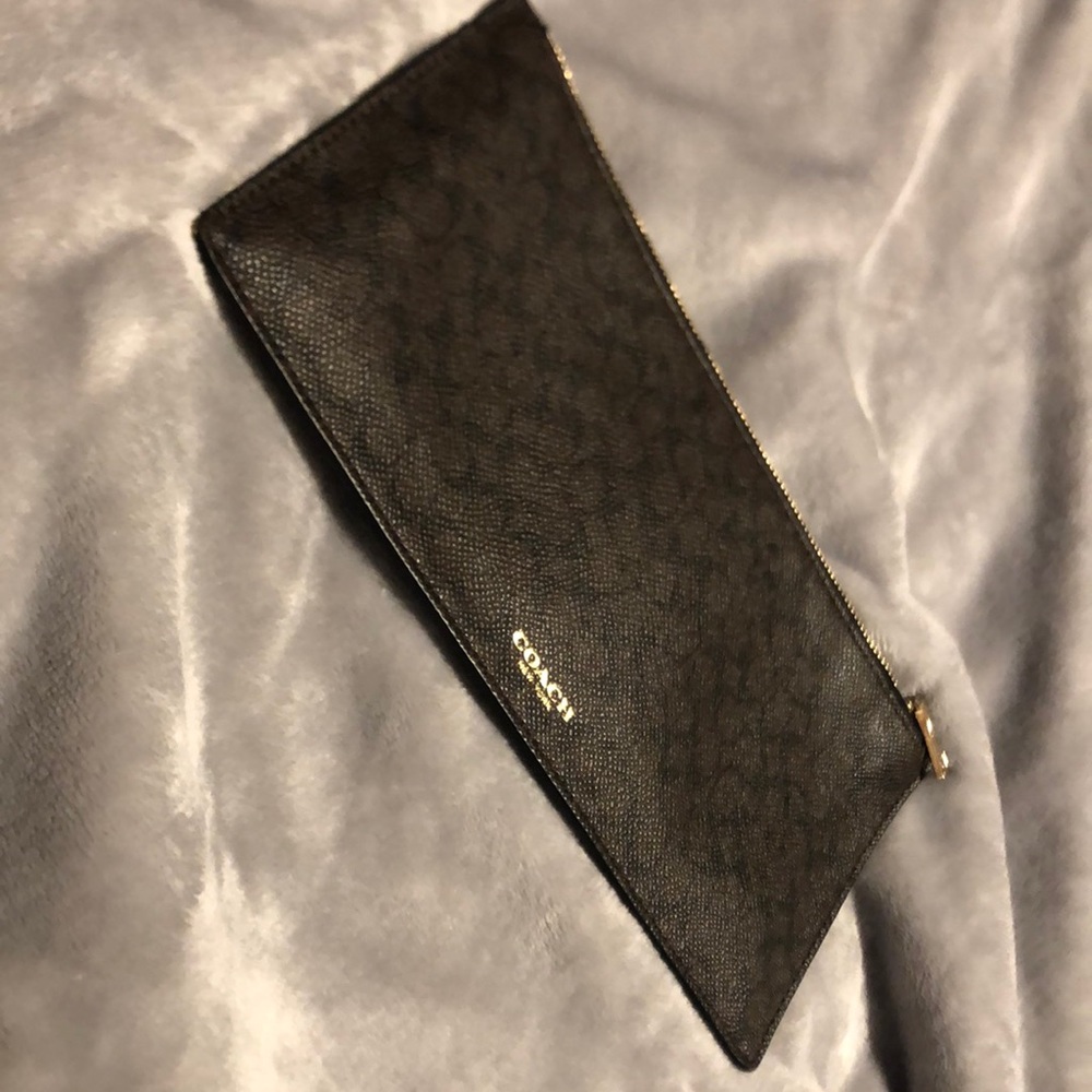 Coach holder, can be used for anything. My passport would not fit into it